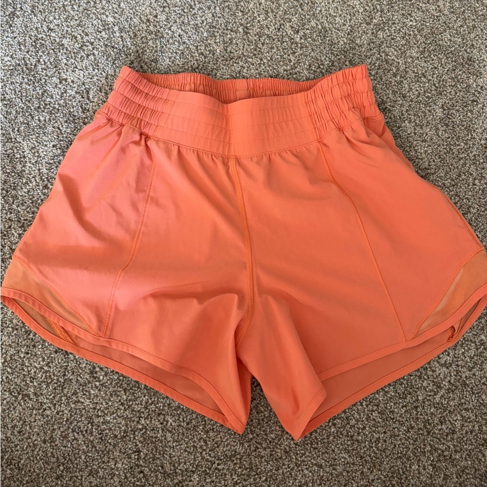 orange/coral colored lululemon shorts, size 4